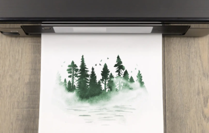 paper coming out of a printer with a forest landscape printed on it