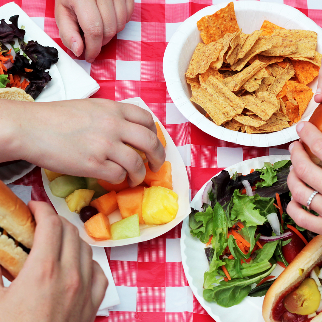 picnic spread on a red and white tablecloth