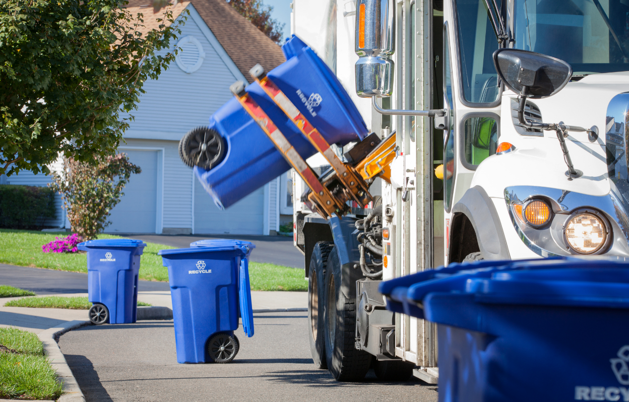 Recycling truck picking up peoples bins