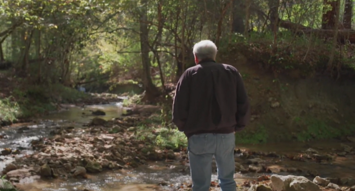 Man standing by a stream