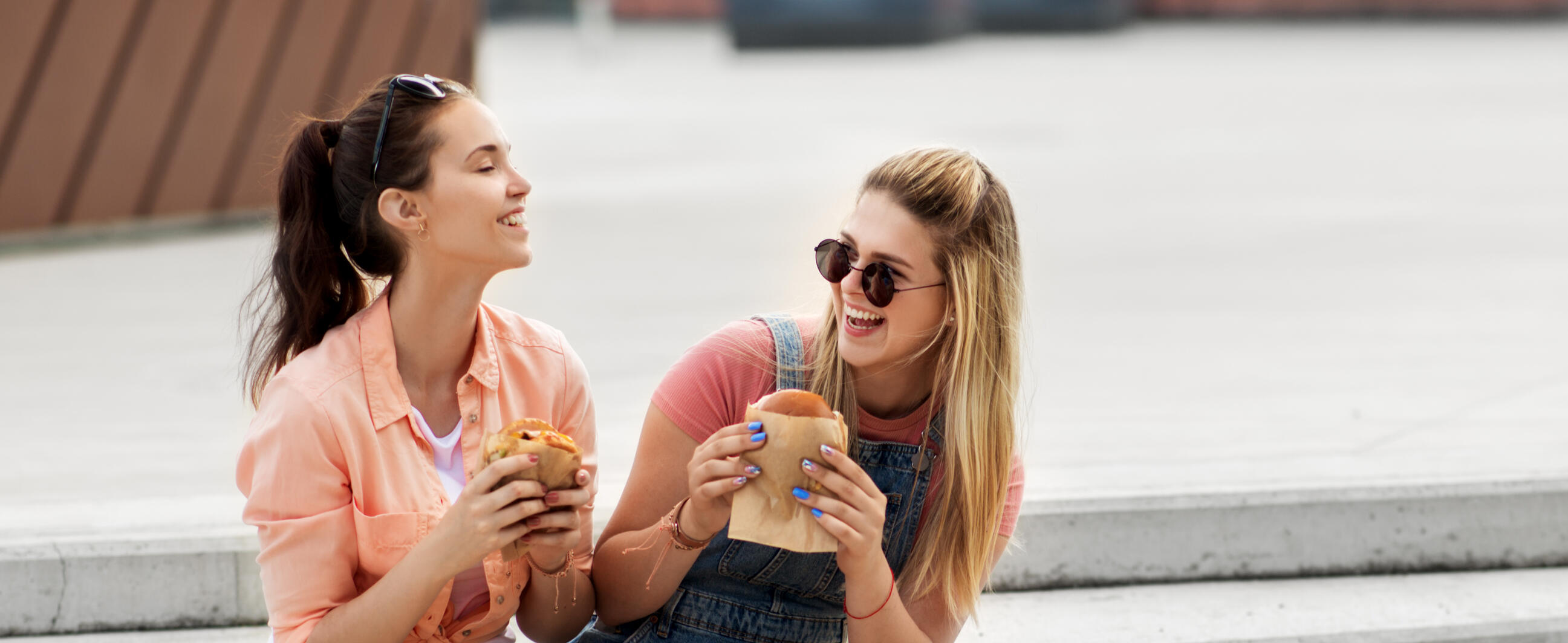 Girls eating food on steps