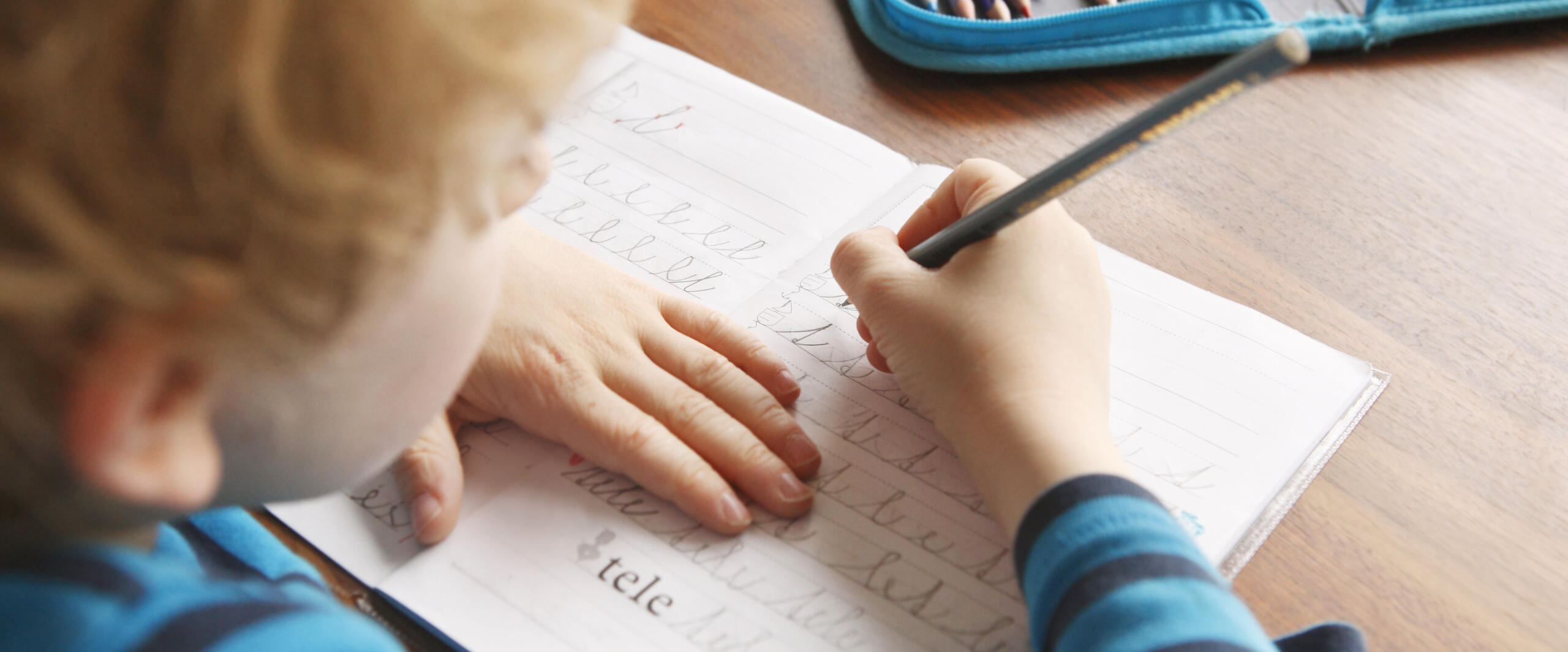Kid writing in notebook