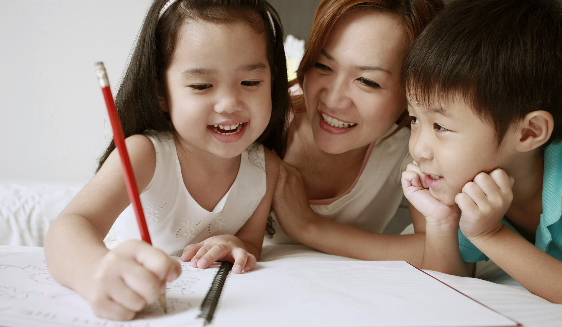 Kids writing with mom