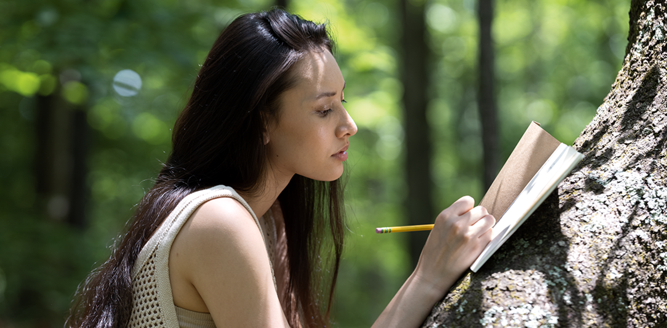 Lady journaling in the forest