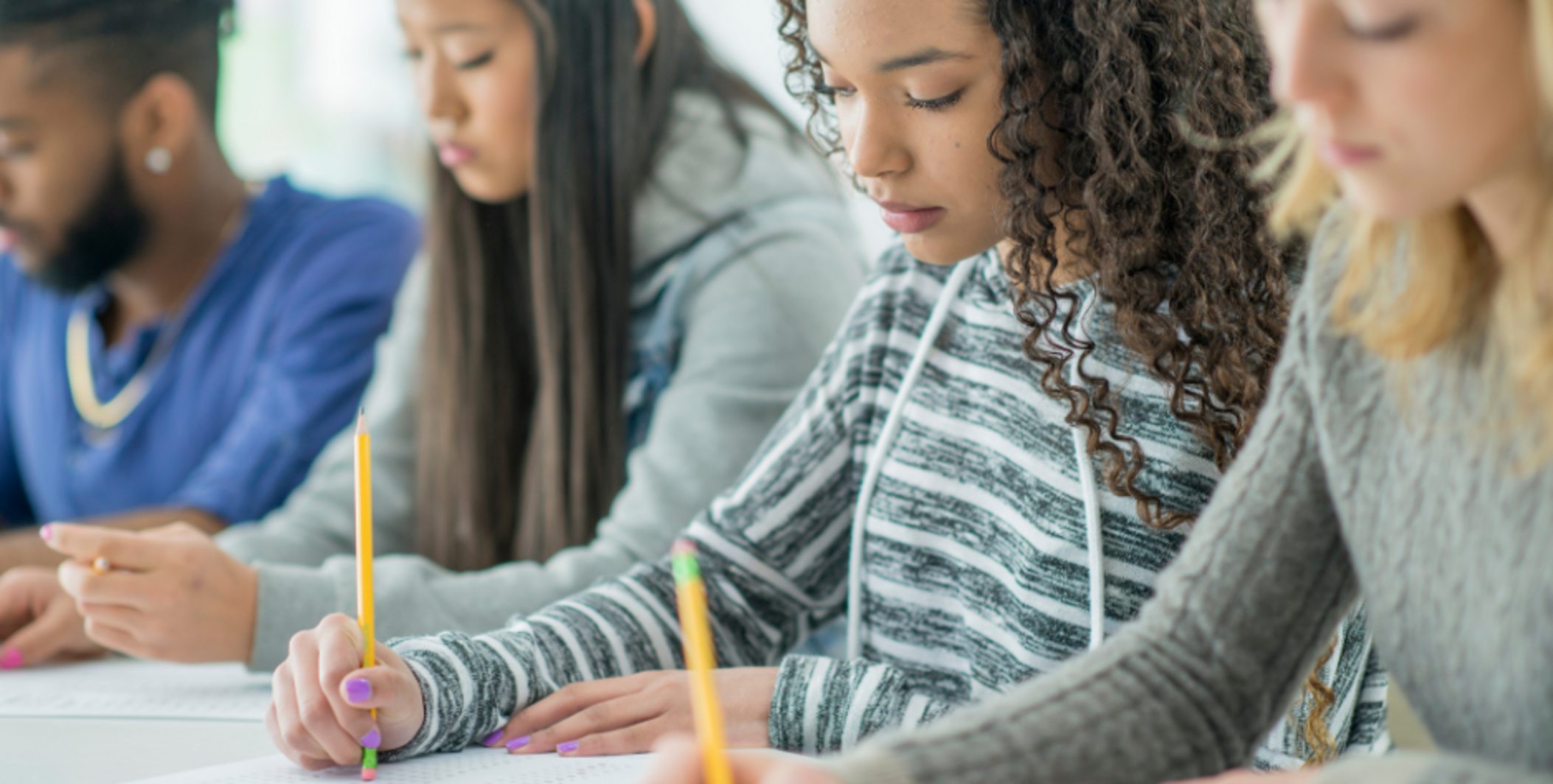 Students taking a test on paper in class