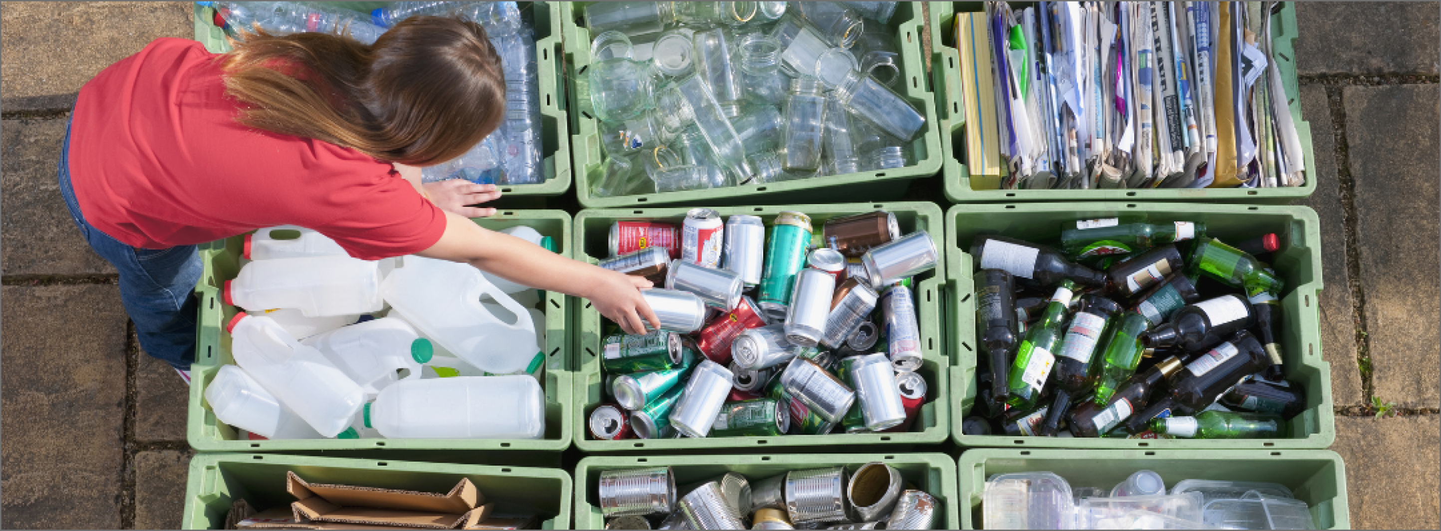 A person sorting recyclable materials into different bins.