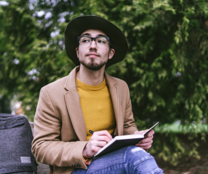 Man journaling in the woods