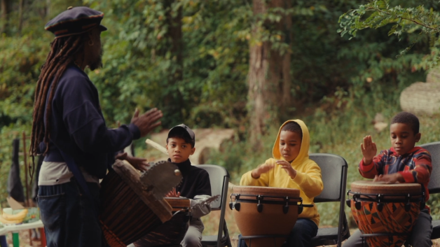 Kids playing drums in the forest