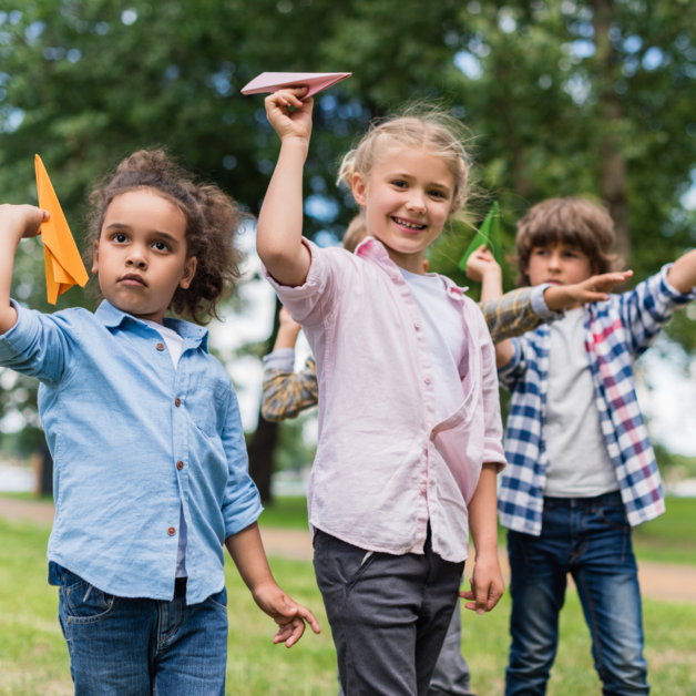 Children playing with paper planes 