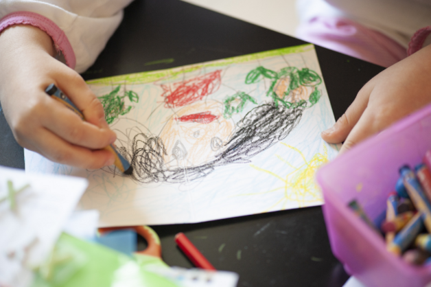 child drawing with crayon