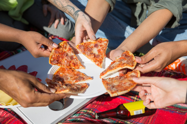 Eating pizza at a picnic