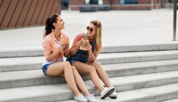 Girls eating food on steps