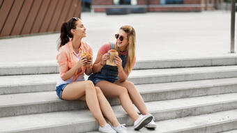 Girls eating food on steps