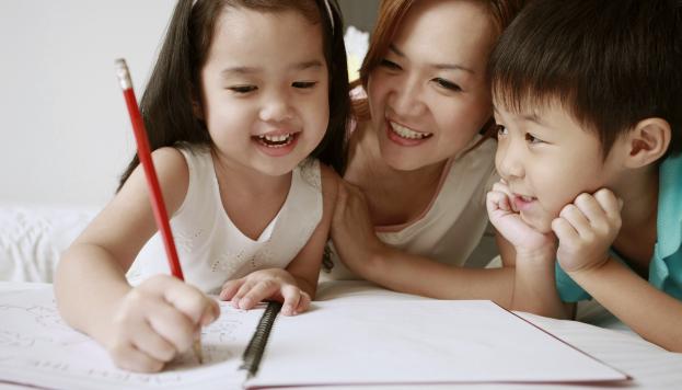Kids writing with mom