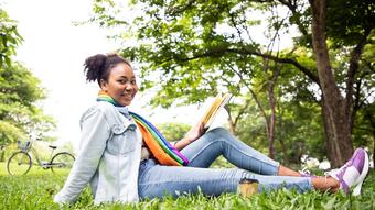 Girl reading book outside