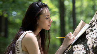 Lady journaling in the forest