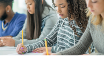 Students taking a test on paper in class