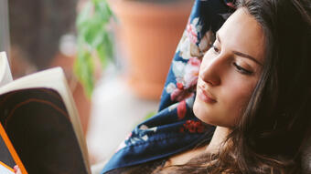 Young woman reading at home