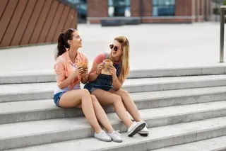 Girls eating food on steps