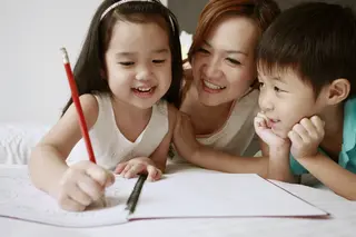 Kids writing with mom