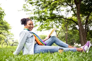 Girl reading book outside