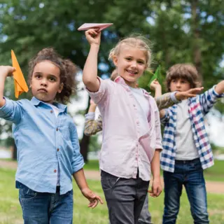 Children playing with paper planes