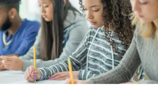 Students taking a test on paper in class